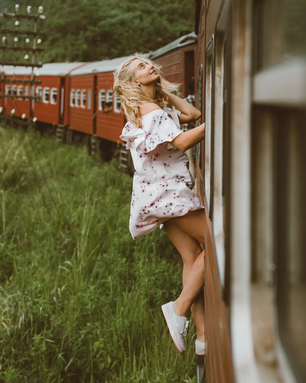 Train passing through lush tea plantations near Ella
